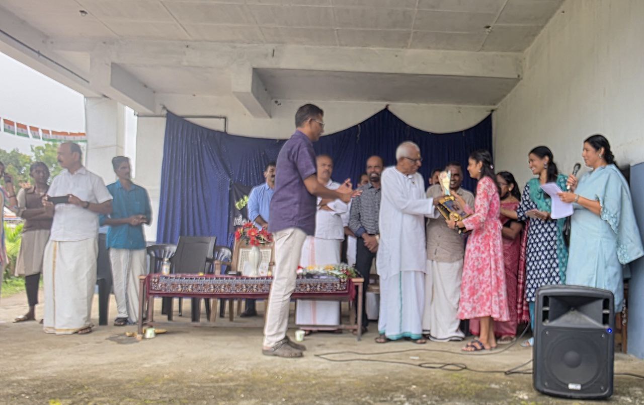 School topper receiving trophy